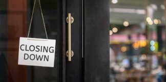 "Closing Down" sign on a shop door.