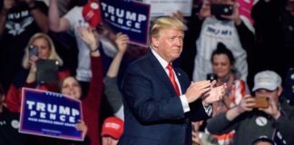 Trump’s Controversial Ukraine Plan: Impact on Global Politics and Leadership Man clapping at a crowded political rally event