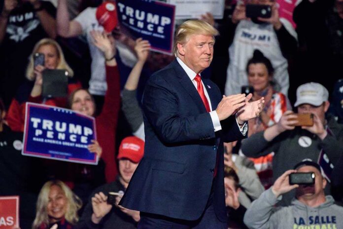 617079032 featured image Man clapping at a crowded political rally event