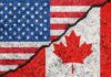 American and Canadian flags separated by a crack
