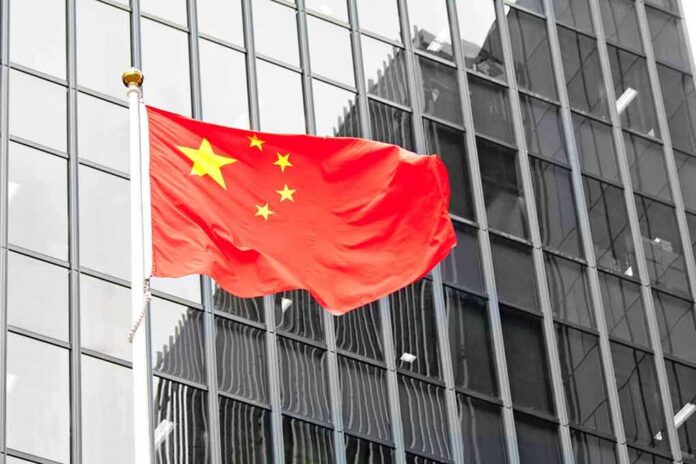 141608113 featured image Chinese flag waving in front of glass building