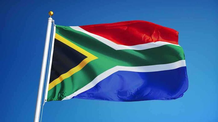 478550506 featured image South African flag waving against blue sky.