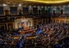 Legislative chamber filled with people during a session