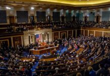 Legislative chamber filled with people during a session