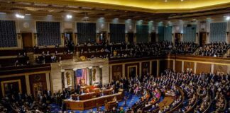 Legislative chamber filled with people during a session
