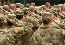 Soldiers in uniform saluting during a ceremony