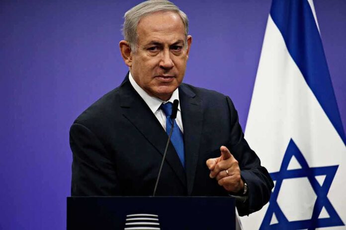 1042782061 featured image Man in suit giving speech in front of Israeli flag