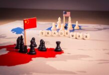 Chess pieces with USA and China flags map