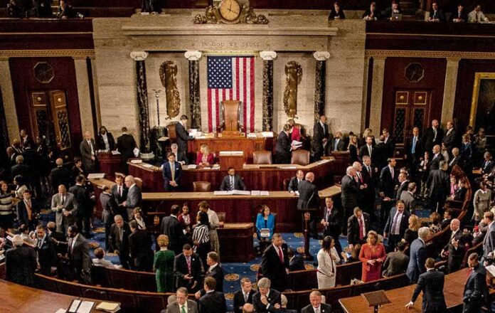 People gathering inside a government building legislative chamber