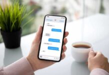 Person holding smartphone with text conversation displayed