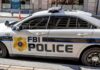 FBI police car parked on city street