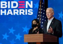Two people speaking at a Biden Harris event