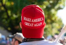 Red Make America Great Again hat on persons head