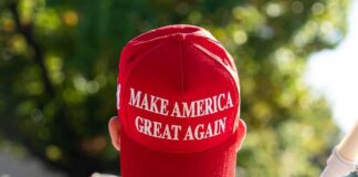 Red Make America Great Again hat on persons head