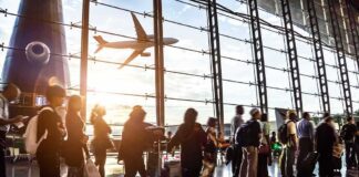 People in line at busy airport terminal