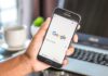 Hand holding smartphone with Google search page