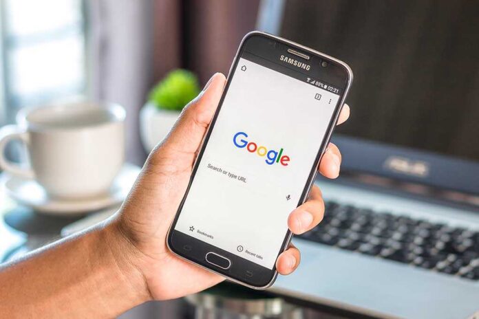 550360213 featured image Hand holding smartphone with Google search page