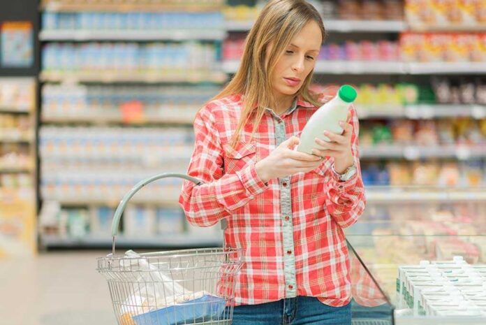1031614558 featured image Woman examining a bottle in a grocery store