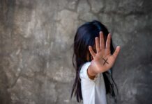 Person with an X on their palm