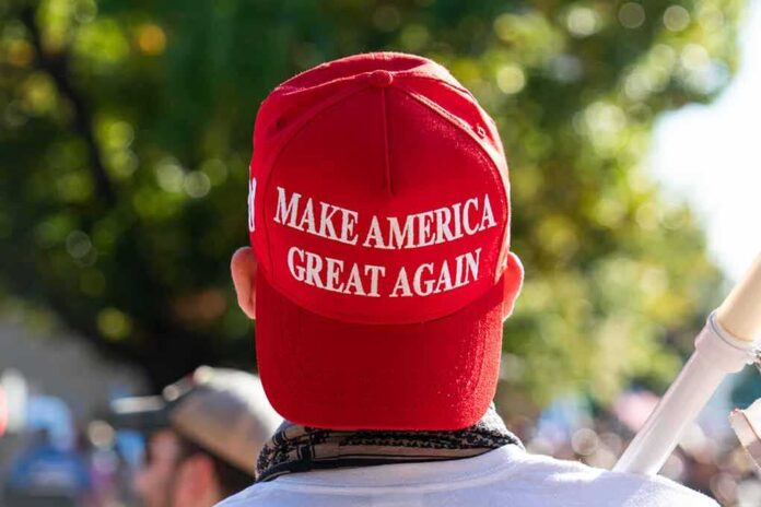 Red Make America Great Again hat on person's head