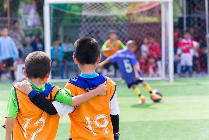 366972005 featured image Two boys watching a soccer game together.