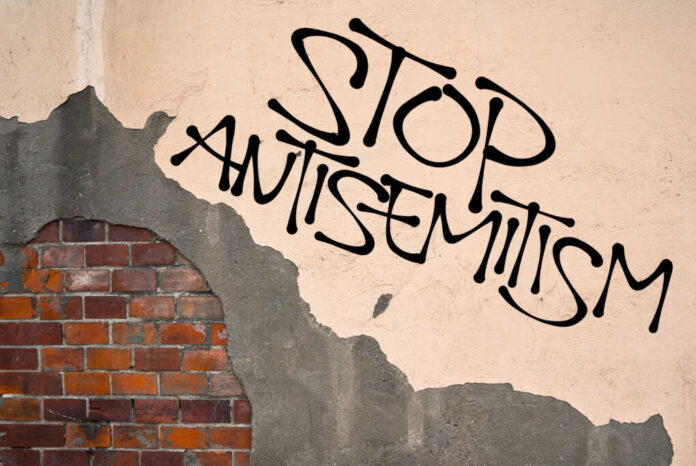 Stop Antisemitism - handwritten_437195251.jpg featured image Stop antisemitism graffiti on a worn brick wall