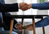 Handshake and exchange of money under the table