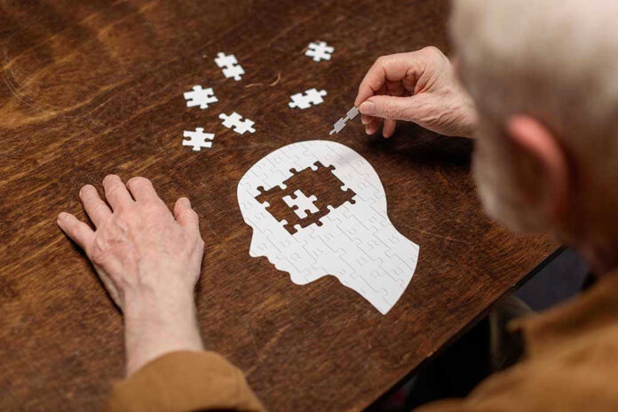 1776503864 Elderly person completing head-shaped jigsaw puzzle