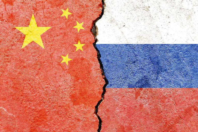 Chinese and Russian flags divided by a crack