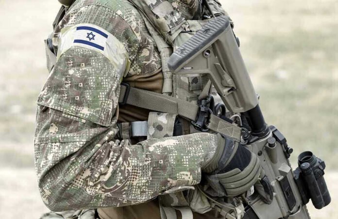 1917131027 Soldier in camouflage gear with Israeli flag patch
