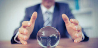Man in suit reaching for crystal ball