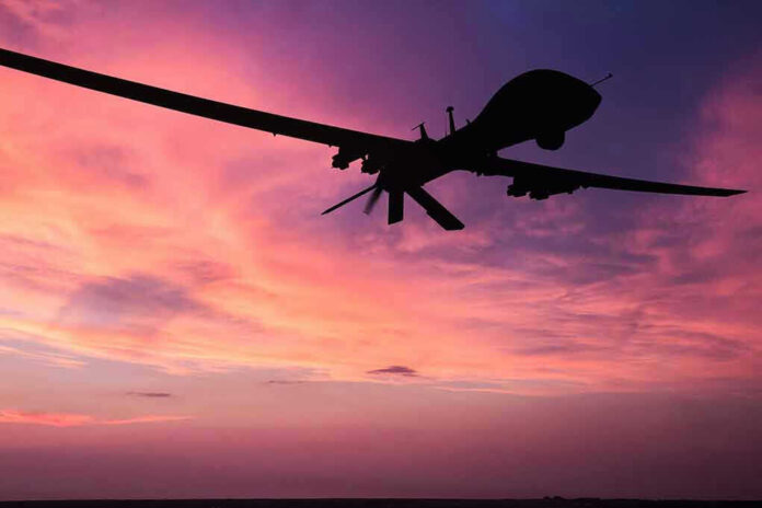 690489076 Silhouette of a drone against a colorful sunset
