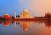 The Taj Mahal reflecting in water during sunset