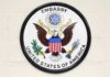 Seal of the United States Embassy featuring an eagle and the American flag