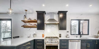 Modern kitchen with black cabinets and stainless appliances.