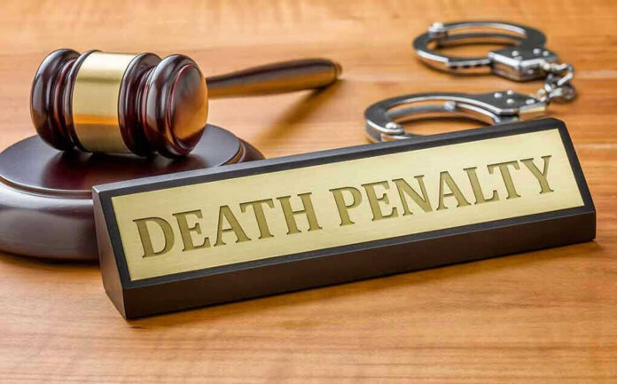 Gavel, handcuffs, and Death Penalty sign on desk.