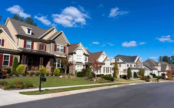 A row of modern suburban houses under a clear blue sky
