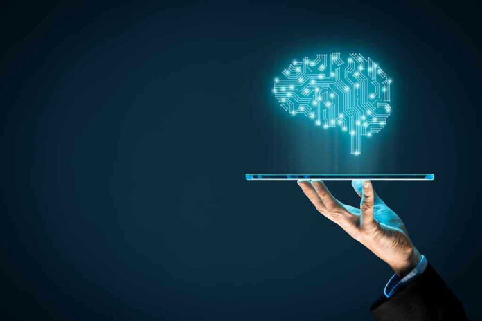 Hand holding tablet projecting digital brain hologram