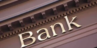 BANK ROBBERY FOILED – Waiter Saves The Day! Close-up of a bank sign with gold lettering