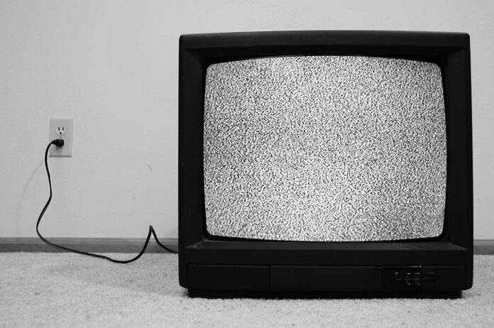 A vintage television displaying static on the screen