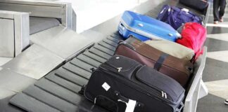 Various suitcases on an airport luggage carousel