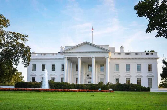 The White House with a fountain and green lawn in front