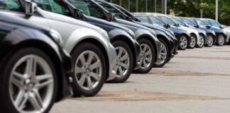 Debt TRAP: 81% of Car Buyers at Risk A row of parked black and silver cars in a dealership