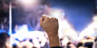 LA Mob Chases Federal AIR MARSHALS Raised fist in a crowd at night.