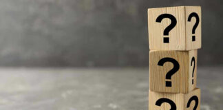 Reparations Fund SIGNED Amidst $1B Deficit! Three wooden blocks with question marks stacked.