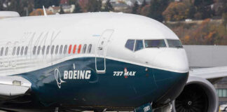 Boeing 737 MAX airplane on runway.