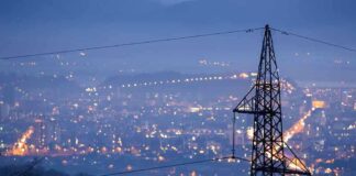 LEFT-WING Terrorists Plunge Major City Into DARKNESS Night view of a city skyline with power lines in the foreground