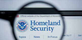 Magnifying glass showing Homeland Security website.