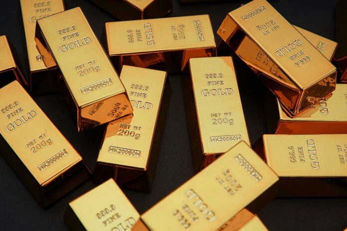 Gold bars stacked on dark background