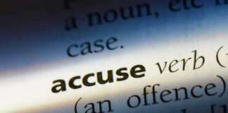 Close-up dictionary definition of accuse underlined.